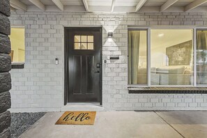A house with a dark front door, white brick exterior, and a large window. - NEW Ocotillo Luxe Retreat Scottsdale Old Town (Scottsdale)