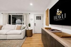 A modern hotel lobby with a reception desk, a sofa, a potted plant, and a large window. - NEW Ocotillo Luxe Retreat Scottsdale Old Town (Scottsdale)