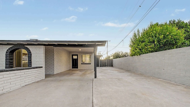 A residential property with a garage, a brick exterior, and a concrete driveway. - NEW Ocotillo Luxe Retreat Scottsdale Old Town (Scottsdale)