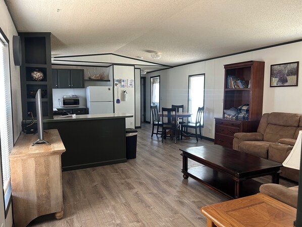 A modern living room with a sofa, a coffee table, and a TV stand.