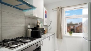 A modern kitchen with a gas stove, a kettle, and a coffee machine. - Belvedere 4-Bed Apt, Sleeps 9 with Parking (Belvedere)