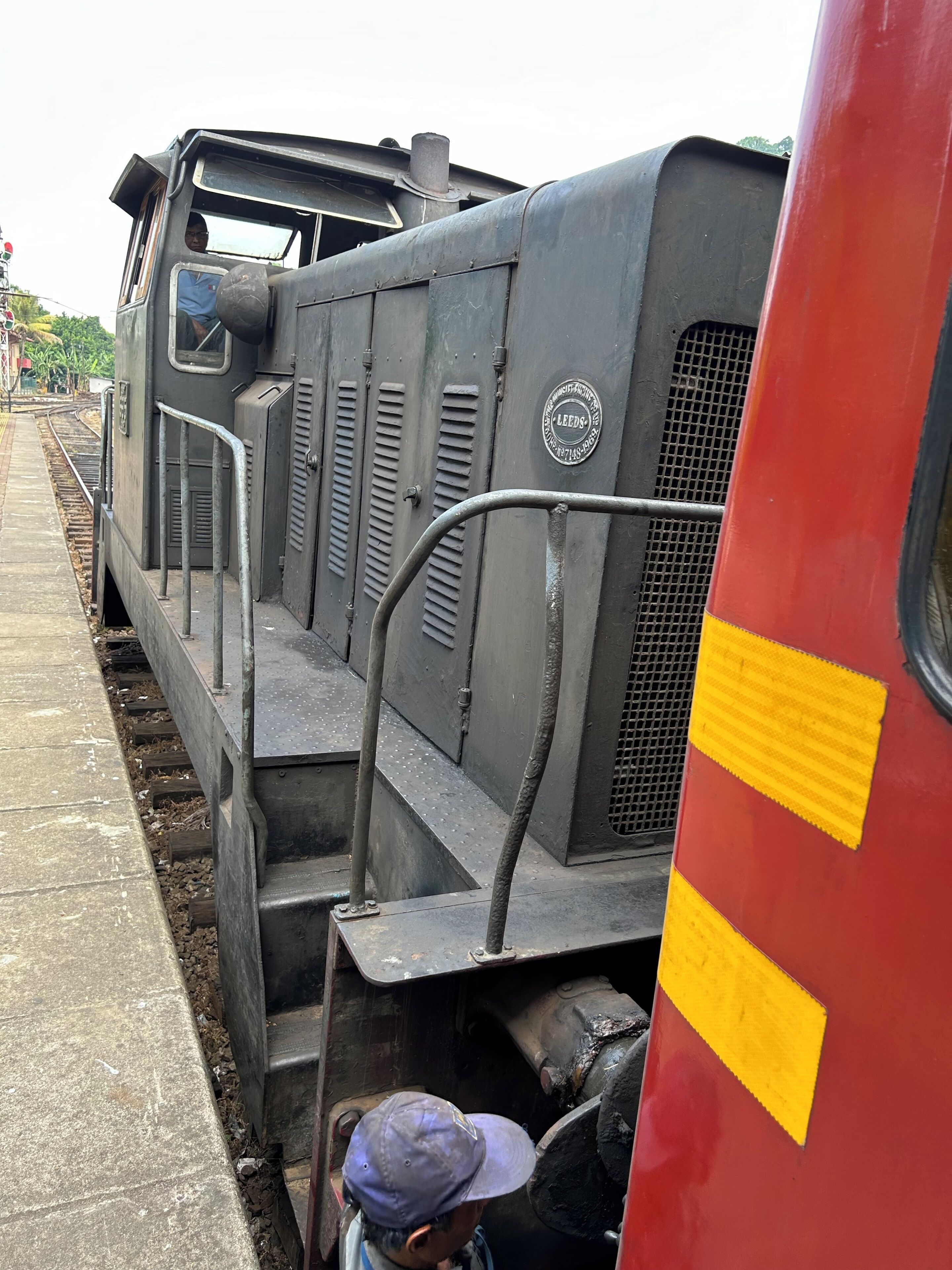 A train with a visible platform and a person standing near the train.