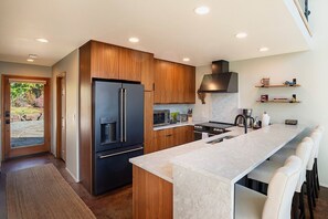 A modern kitchen with a built-in refrigerator, stove, and microwave.