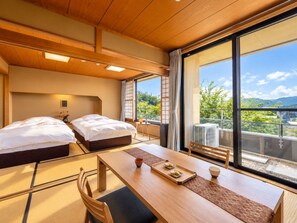 A hotel room with two beds, a dining table, and a view of the outdoors. - SANEIKAKU (Matsumoto)