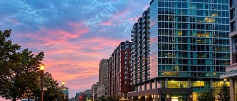 A multi-story building with a modern architectural style, featuring a glass facade and a series of balconies.