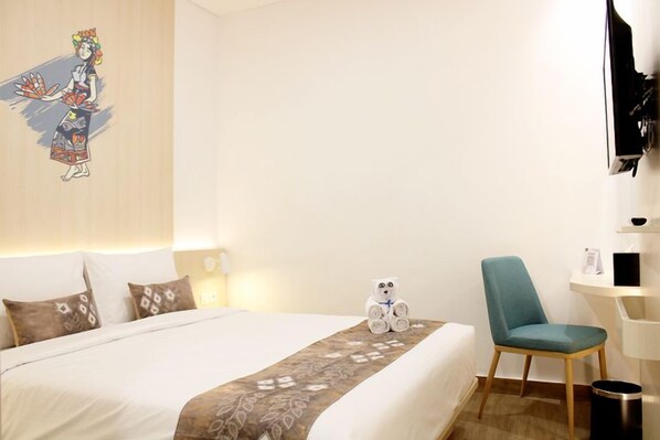 A hotel room with a bed, a chair, a wall-mounted TV, and a decorative wall piece.