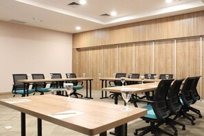 A conference room with multiple tables and chairs, equipped with glassware. - Cordia Banjarmasin (Banjarbaru)