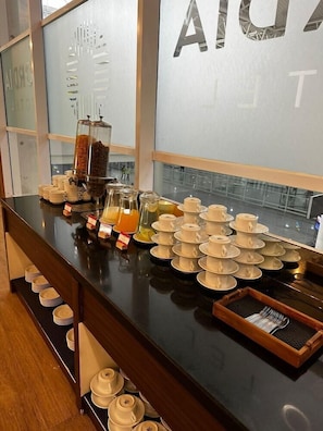 A buffet setup with various food items and condiments.
