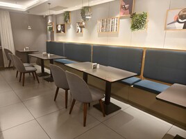 A restaurant interior with booths, tables, and chairs.
