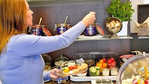 A buffet setup with various food items and condiments. - Hotel Sandmanns Am Dom (Cologne)