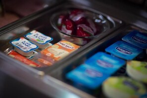 A refrigerated display with various dairy products including cheese and yogurt. - Hã´tel Akena Nantes (Sainte-Luce-sur-Loire)