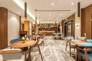A modern hotel lobby with a bar area, seating arrangements, and a marble floor. - Ssaw Boutique Hotel Cheng Man (Shanghai)
