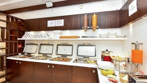 A buffet area with multiple food dispensers, a self-service beverage station, and a variety of breakfast items. - Mango Hotels Vybrant Vijayawada by Othpl (Vijayawada)