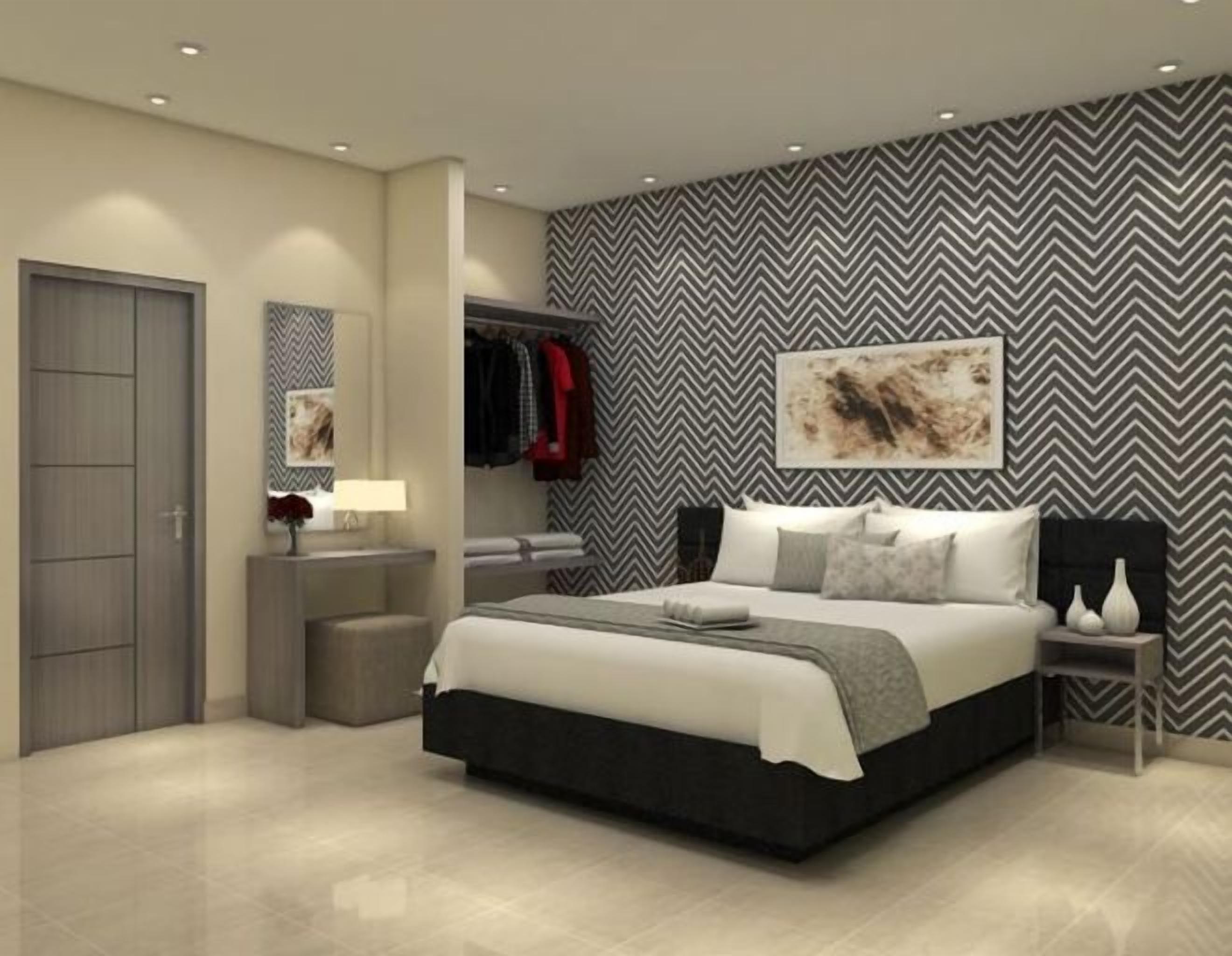 A modern bedroom with a large bed, bedside tables, a wardrobe, and a mirror.
