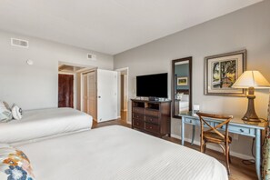 A hotel room with two beds, a desk, a television, a lamp, and a mirror. - Gorgeous 5th Floor Oceanfront Views | Pet Friendly | Super Spacious 1 Bedroom (Fernandina Beach)