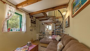 A cozy living room with a sofa, a wooden coffee table, and a window with curtains. - Holiday Home Ruby, Polje, Croatia (Polje)