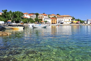 A clear waterfront with boats docked, buildings in the background, and a clear view of the water. - Holiday Home Ruby, Polje, Croatia (Polje)