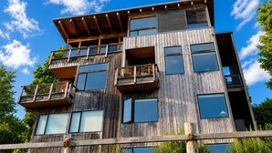 A multi-story wooden building with balconies and large windows. - Downtown Langley I Beachfront I Whale Watching (Langley)