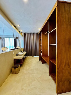 A modern bathroom with a vanity, mirror, and wooden shelving unit. - Joanza By Ool Hotels (Isla Holbox)