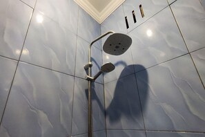 A shower with a handheld showerhead and a wall-mounted control panel. - Oyo 93749 Aksana Homestay Syariah (Purwokerto)