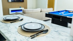 A dining area with a pool table and a television in the background. - Inviting 1 Bed House In Bradford (Bradford)