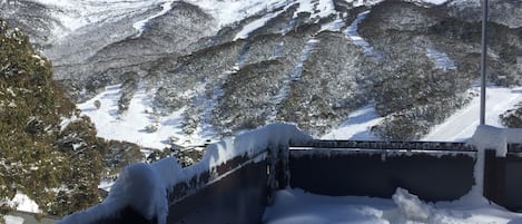A snow-covered mountain landscape with a clear sky.
