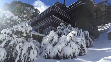A building with a snow-covered roof and a sign that reads 'Marechaussee.'
