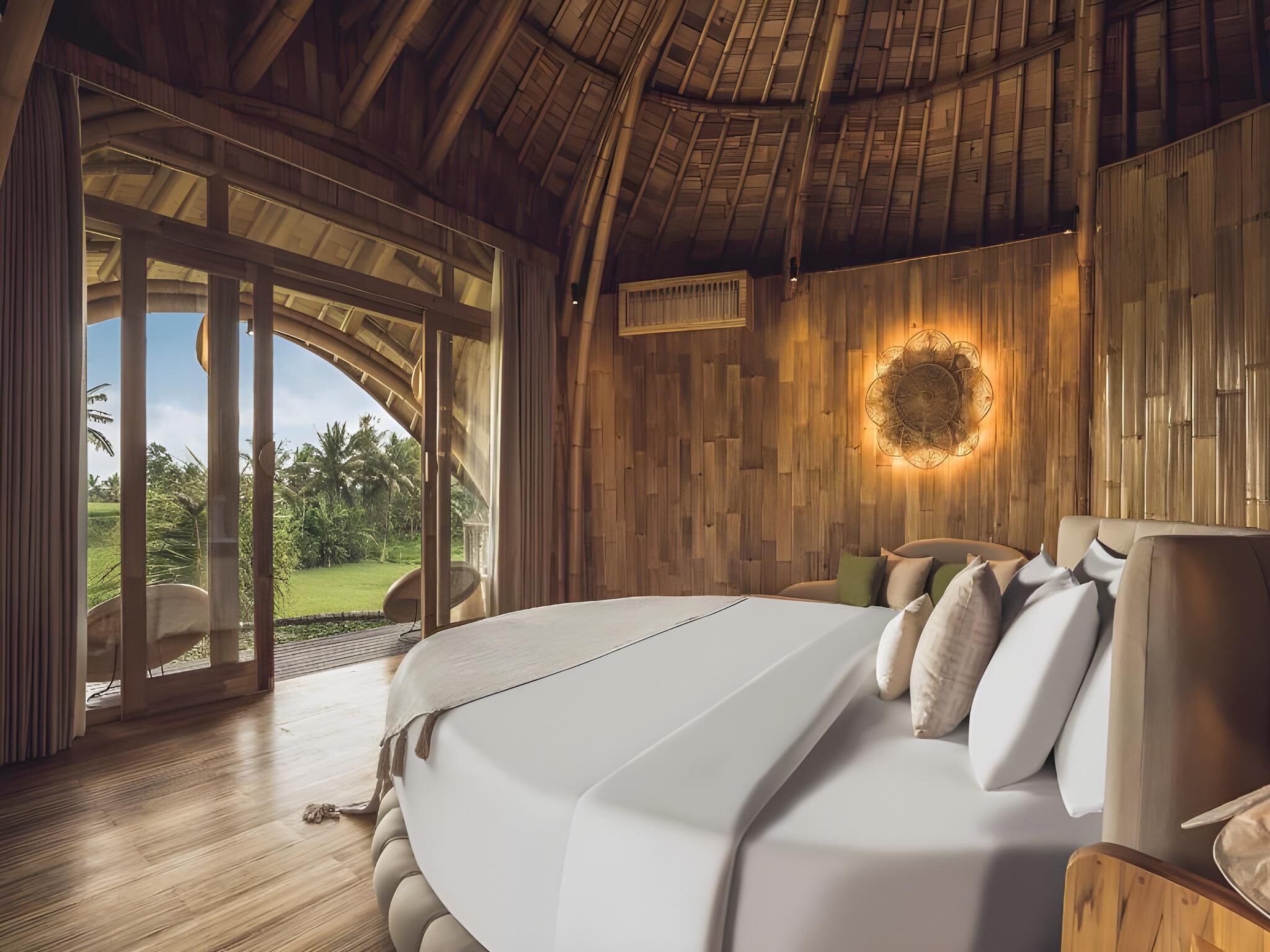 Un dormitorio con una cama grande, paredes de madera, un ventilador de techo y vistas al exterior.