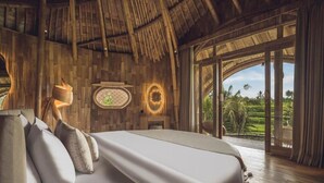 A room with a bed, a wall clock, and a view of greenery outside. - Equipoise Resort Ubud by Ini Vie Hospitality (Tegallalang)