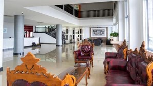 A spacious lobby with a high ceiling, a reception desk, and seating areas with ornate furniture. - 21 Karimun (Karimun)