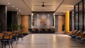 A spacious lobby with a reception desk, seating area, and a decorative wall. - Laska Hotel and Resort Ciletuh (Girimukti)