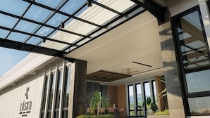 A modern building with a glass facade, large windows, and a flat roof. - Laska Hotel and Resort Ciletuh (Girimukti)