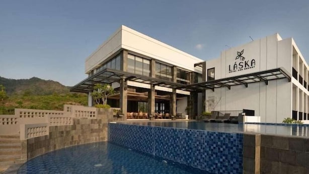 A modern building with a pool, outdoor seating, and a sign reading 'LASKA'. - Laska Hotel and Resort Ciletuh (Girimukti)