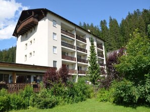A multi-story building with balconies, surrounded by greenery and trees. - Cristallina I, (Laax Uletsch), 37021 by Interhome (Laax)
