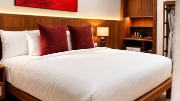 A hotel room with a large bed, wooden headboard, a red abstract painting, a nightstand, a bedside table with a lamp, and a wooden wardrobe.