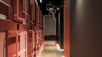 A corridor with bunk beds and a fire extinguisher.