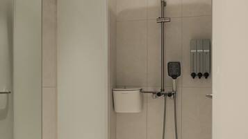 A modern shower with a handheld showerhead, a wall-mounted control panel, and a glass-enclosed shower area.