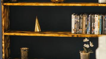 A bookshelf with a variety of items including books, a decorative bowl, and a small plant.