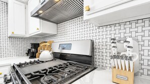 A modern kitchen with a stainless steel range, a digital control panel, and a knife block. - Cozy East Austin 3BR for 6, Near DT & Rodeo Austin! (Austin)