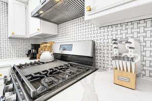 A modern kitchen with a stainless steel range, a digital control panel, and a knife block. - Cozy East Austin 3BR for 6, Near DT & Rodeo Austin! (Austin)