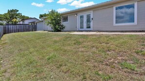 A single-story house with a front door, a small front yard, and a wooden fence. - Cozy East Austin 3BR for 6, Near DT & Rodeo Austin! (Austin)