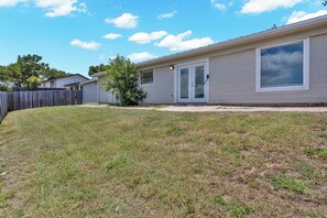A single-story house with a front door, a small front yard, and a wooden fence. - Cozy East Austin 3BR for 6, Near DT & Rodeo Austin! (Austin)