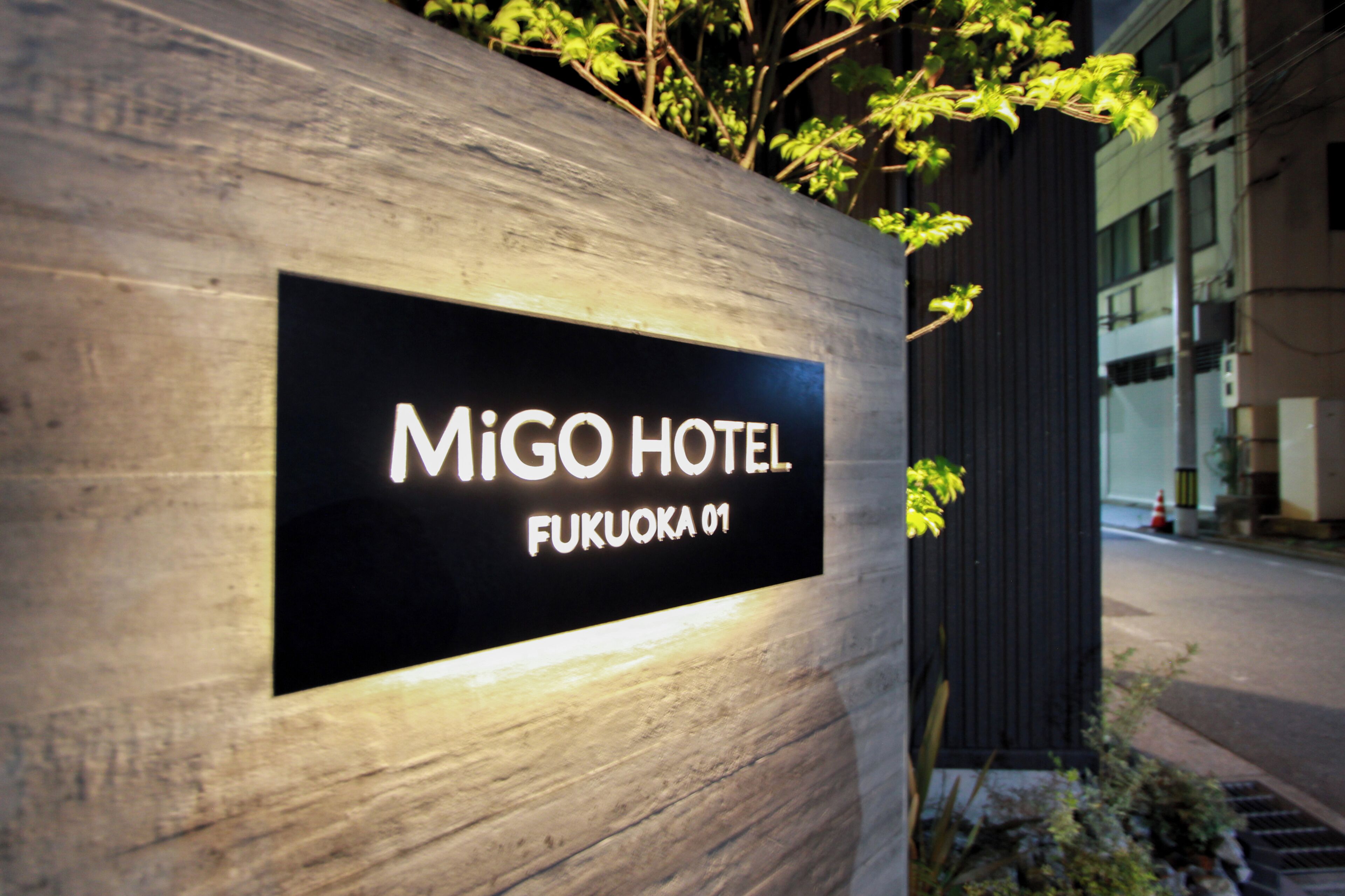 A sign for MiGO Hotel with a modern design, located at Fukuoka 01.
