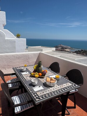 A table set with fruits and pastries on a terrace overlooking the sea. - Mirador of the Mediterranean, (Peñíscola)