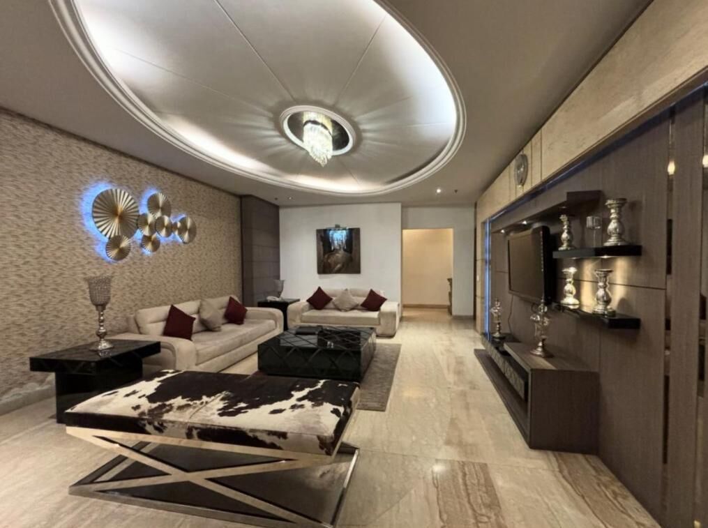 A modern living room with a sofa, coffee table, and decorative wall art.