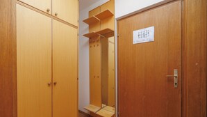 A wooden wardrobe with a mirror and a door with a lock. - Charming Studio Rental in Malinska with Garden View (Malinska-Dubašnica)