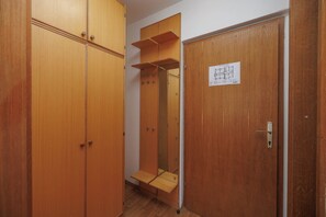 A wooden wardrobe with a mirror and a door with a lock. - Charming Studio for 4 persons in Malinska (Malinska-Dubašnica)