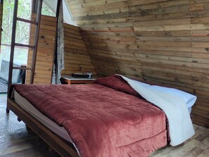 A room with a bed, a small table, and a window. - cabaña con baño interno, en el balcón jacuzzi (Quebradanegra)