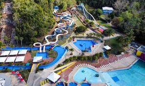 A water park with multiple slides and pools. - Los Flamboyanes Cozy Suite (Aguadilla city)