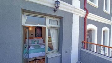 Ein Zimmer mit Bett, Fenster und Balkon.